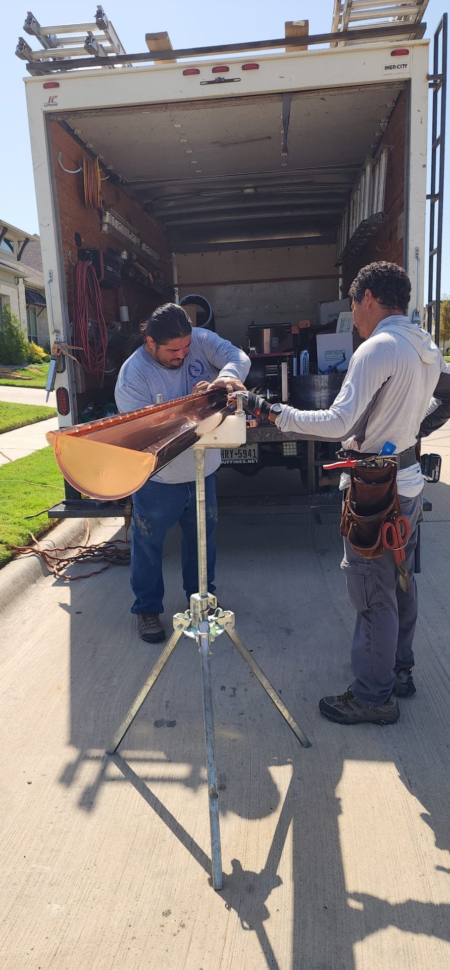 2 people installing copper gutters