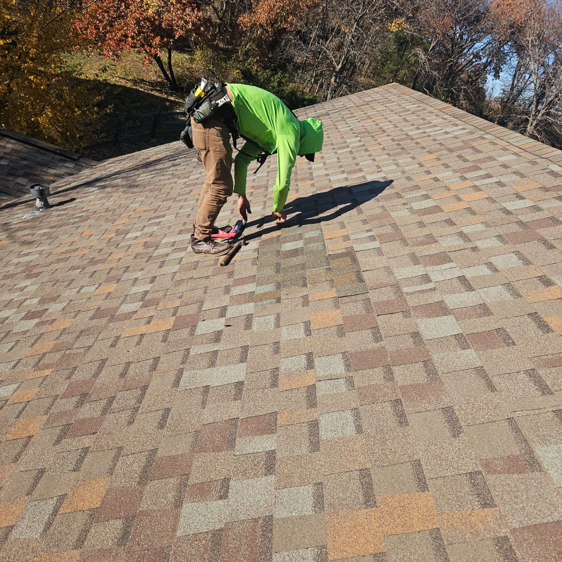 man on the roof checking for damages