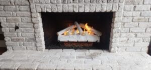 Lit Fireplace made of white bricks