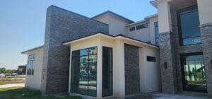 modern house with mixed stone and vnyl siding design