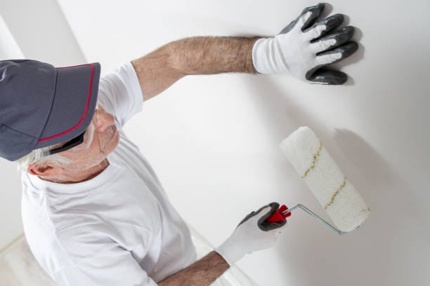 man painting on wall